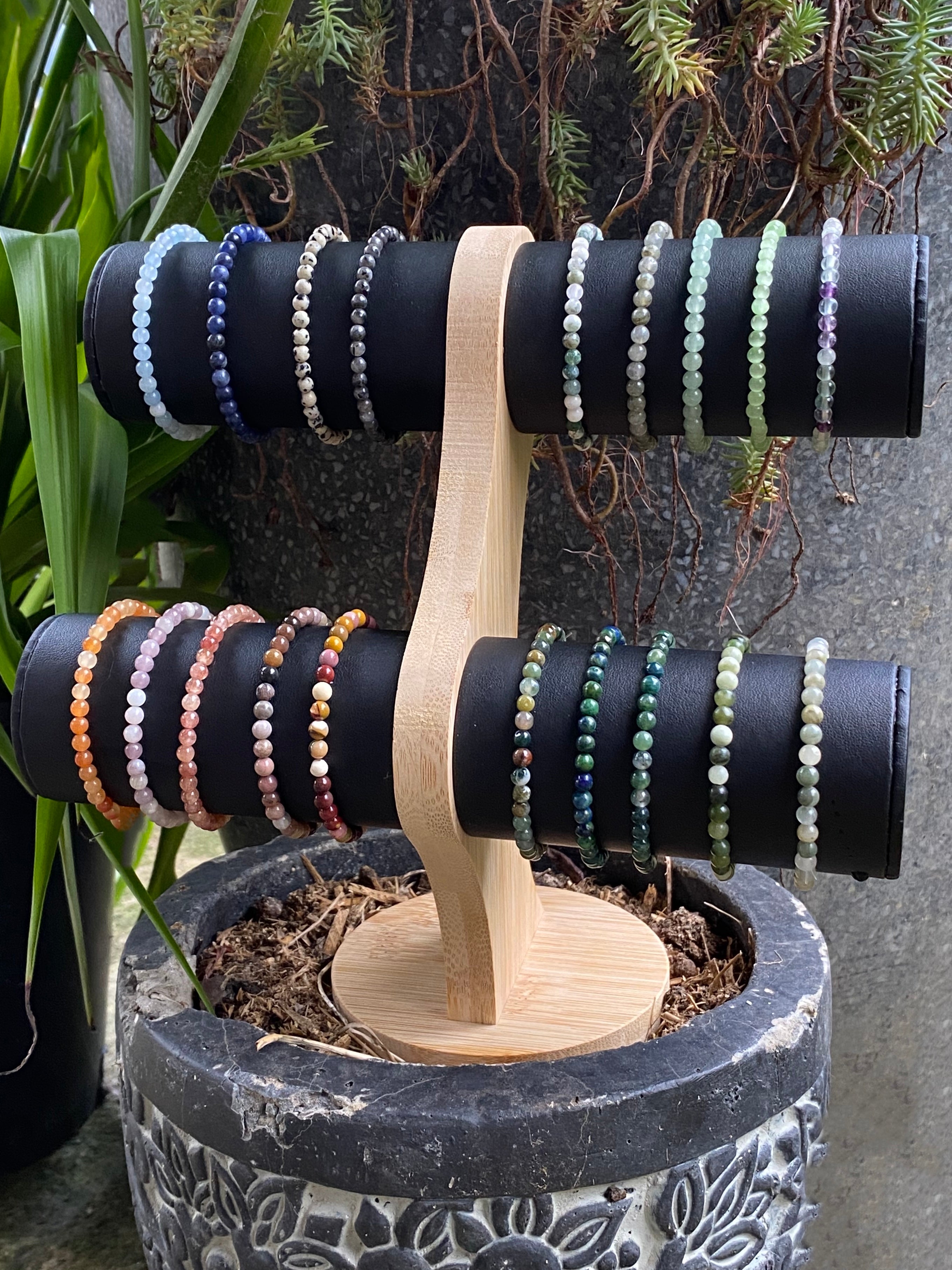 a display stand showing three different stacking stretch bracelets made with 4mm Sodalite, Labradorite, and Moss Agate stones.