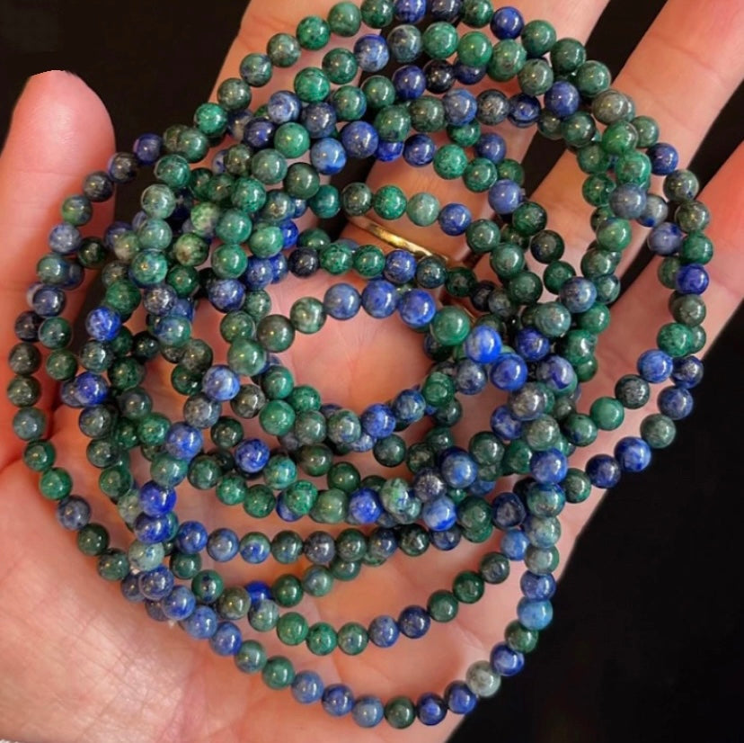 a stack of lapis stacking stretch bracelets made with 4mm beads