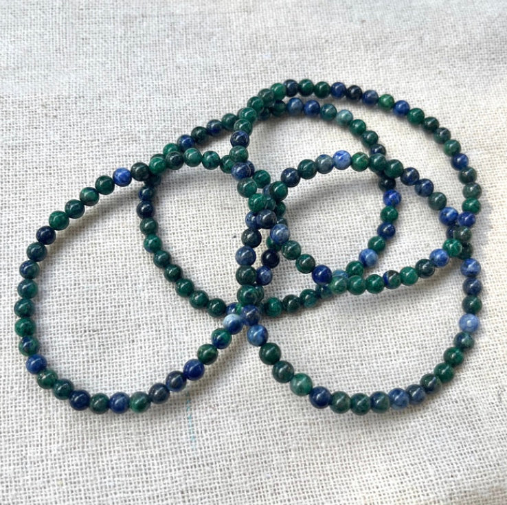 a stack of lapis stacking stretch bracelets made with 4mm beads