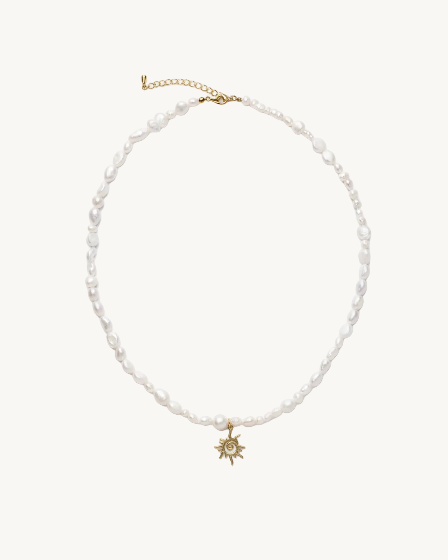 Pearl necklace with a gold sun pendant