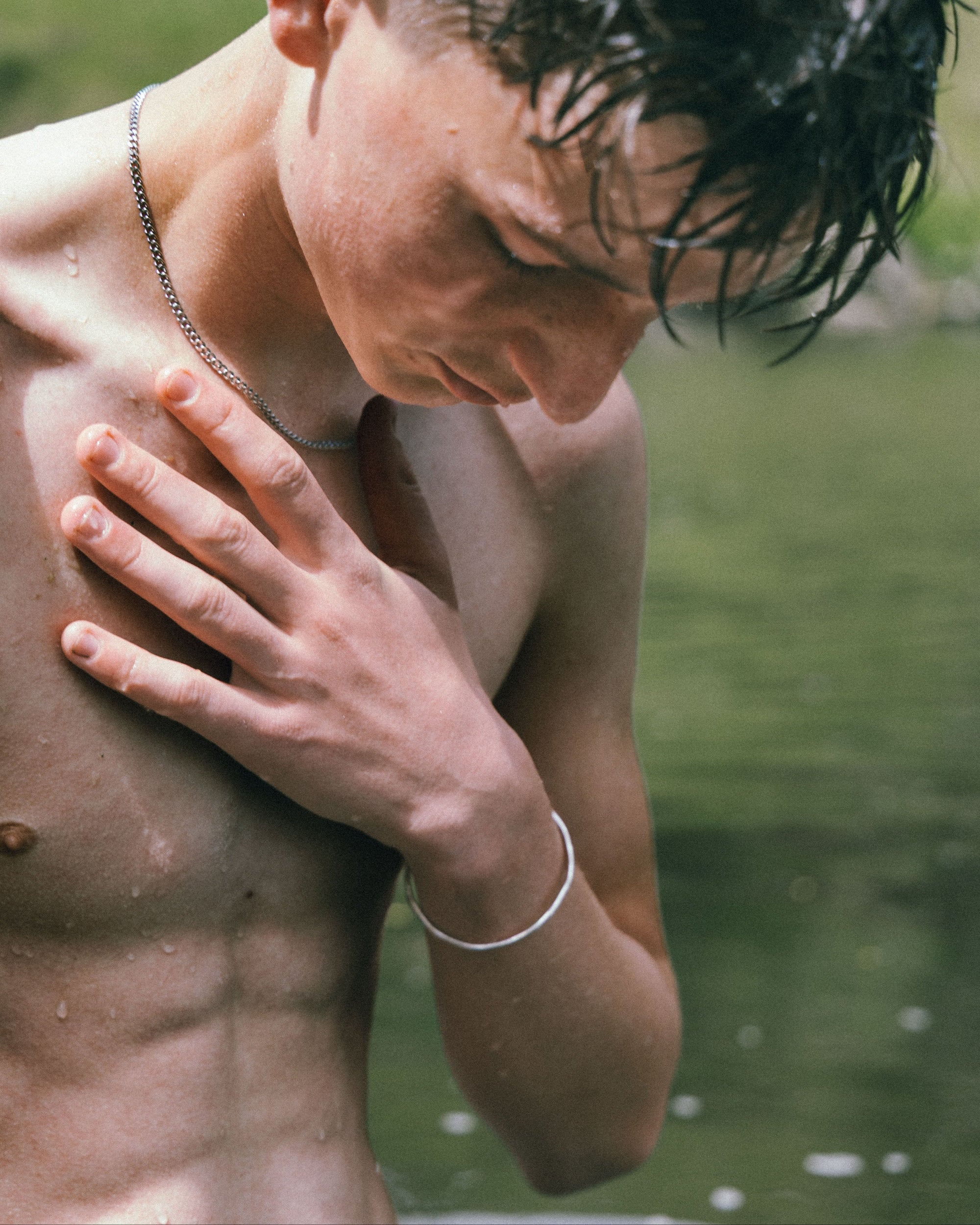 Person under a shower with water droplets visible