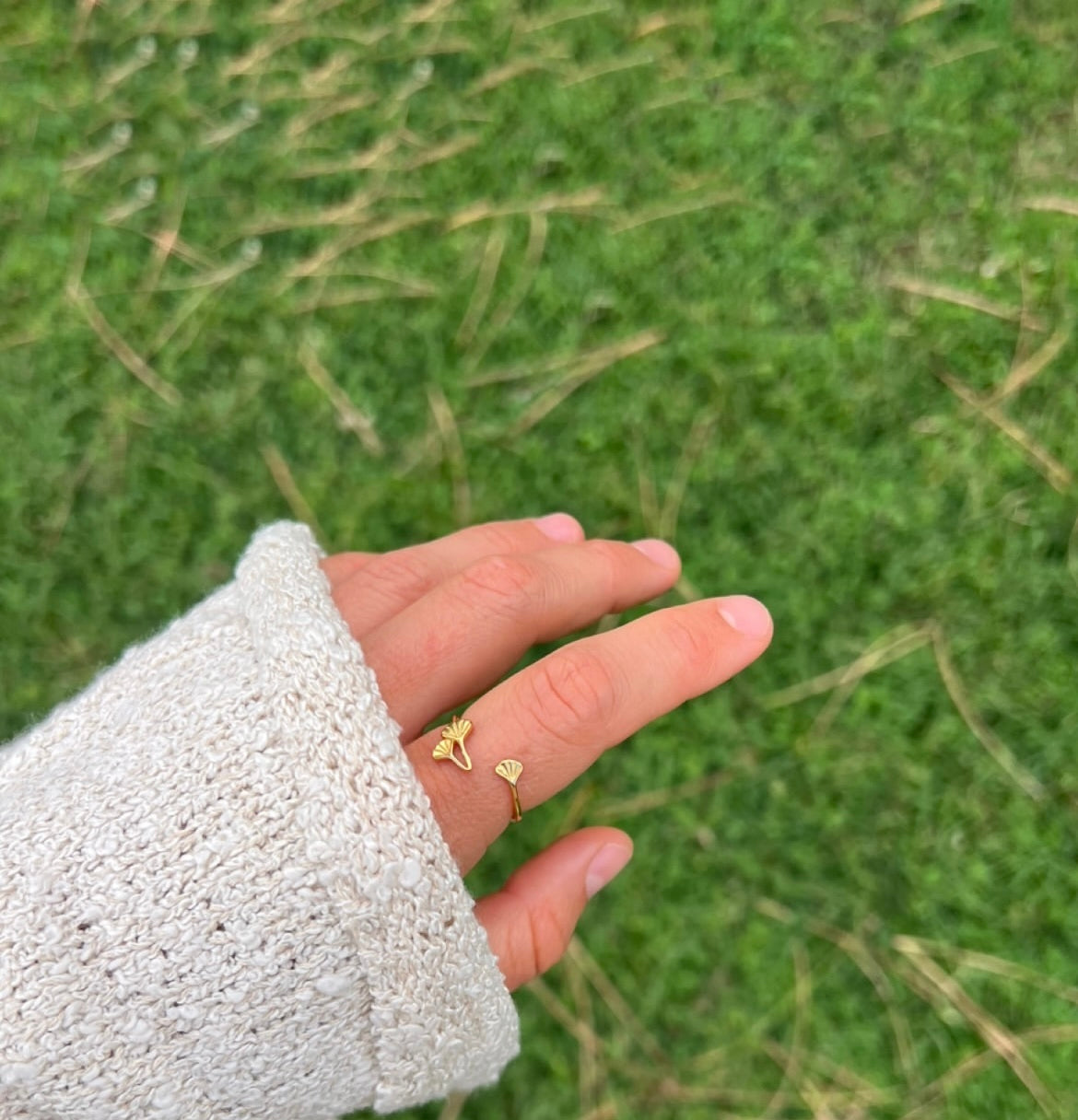 Gold Plated Ginkgo Ring on models hand showing the intricate, adjustable floral plant design and adjustability