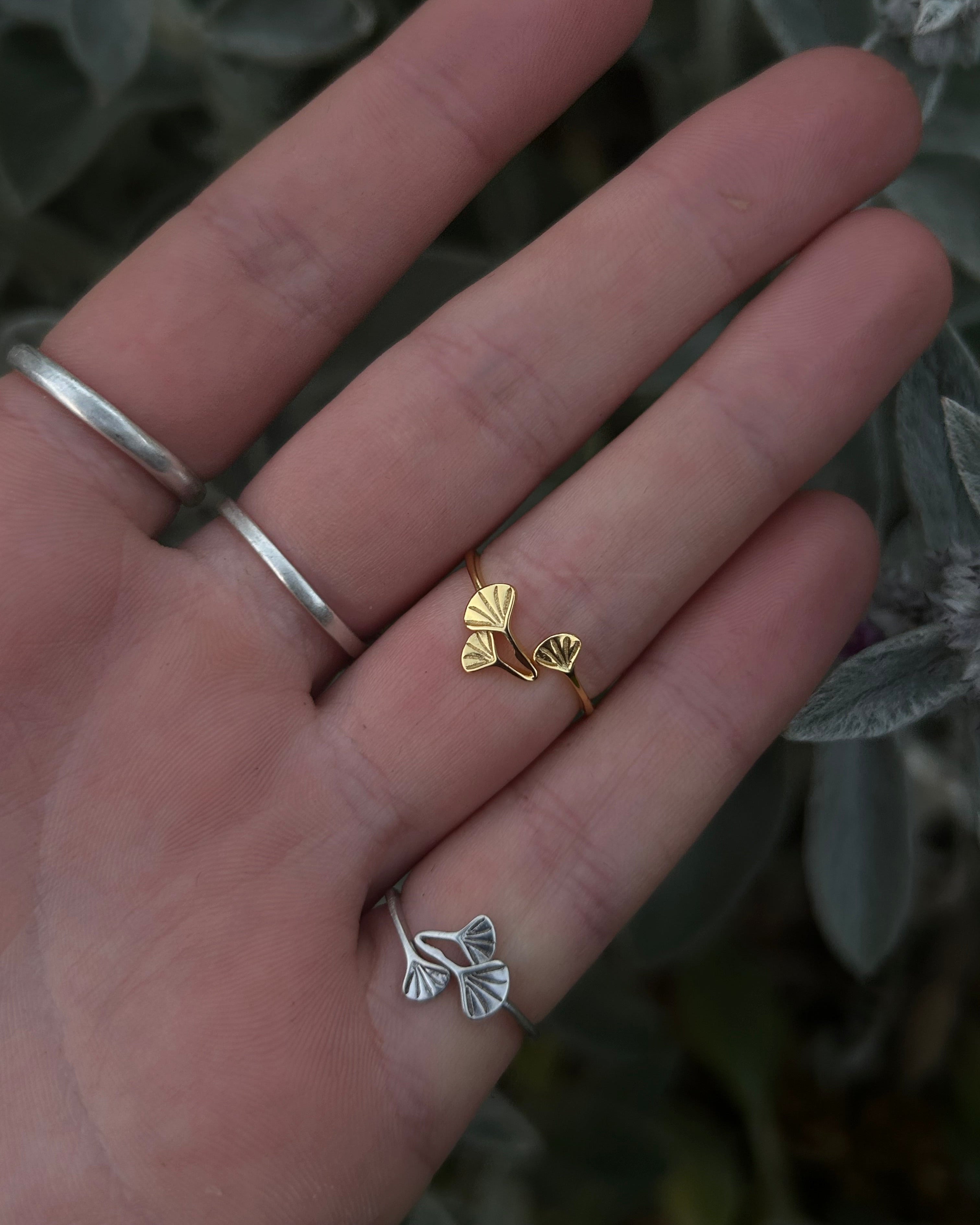 Close-up on hand of the Handmade Gold and silver Ginkgo Ring showing the intricate, adjustable floral plant design.