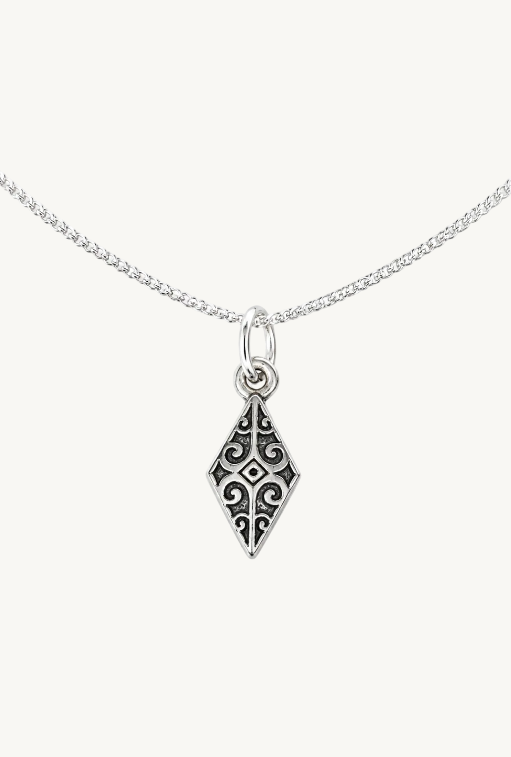 A silver chain necklace featuring a diamond-shaped pendant with an ornate filigree cutout pattern, shown against a plain white background.