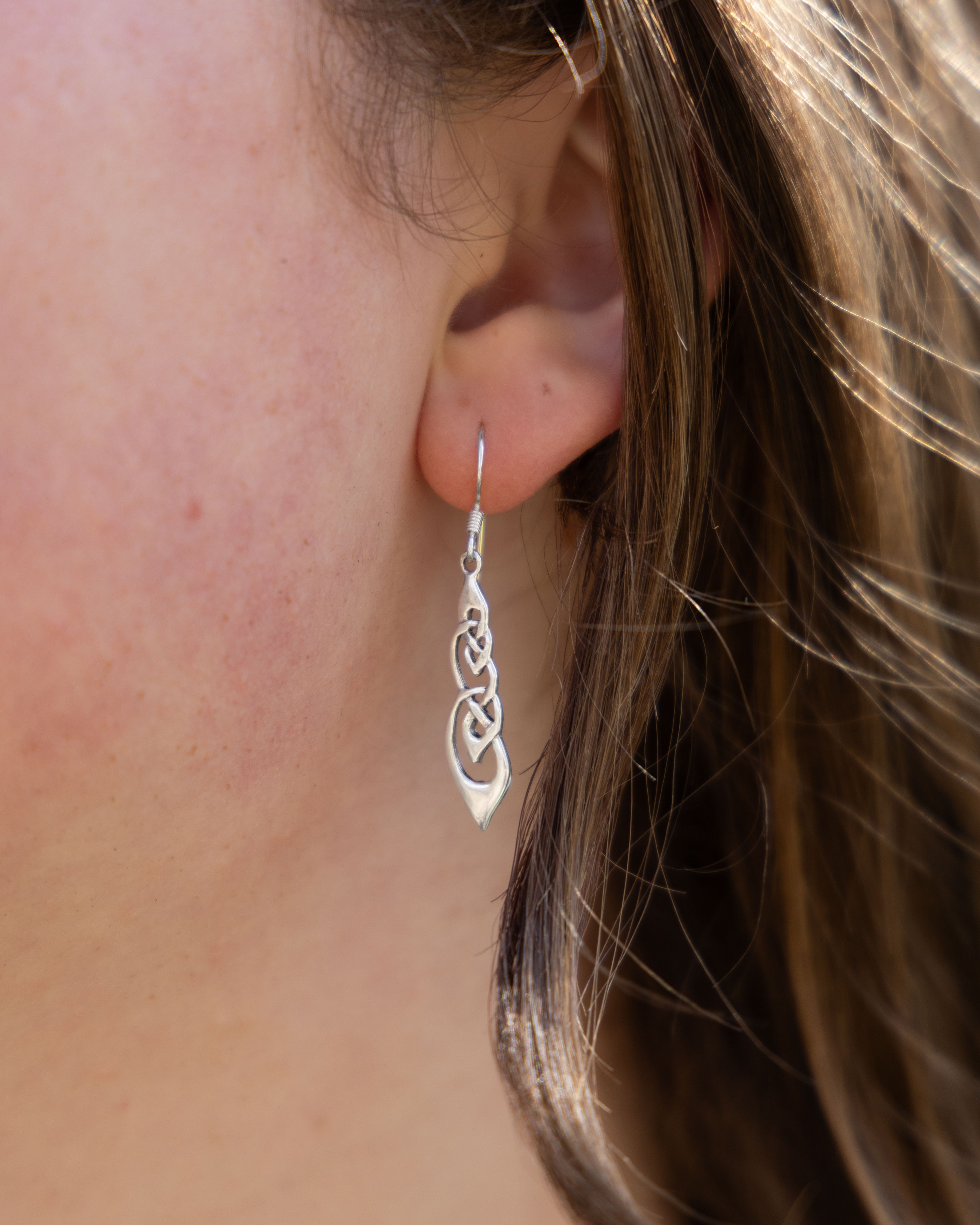 Close-up of a silver Celtic knot medieval inspired earrings