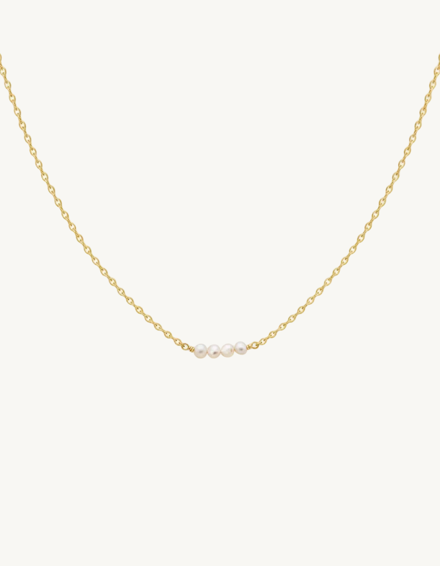 Gold chain necklace with three pearls