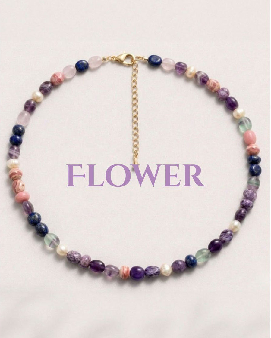 Multicolored beaded necklace on a light pink background with 'FLOWER' text.