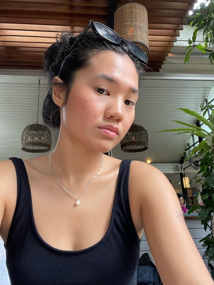 Close-up of a model wearing the Classic silver Pearl Necklace, showing the subtle single pearl drop pendant detail.