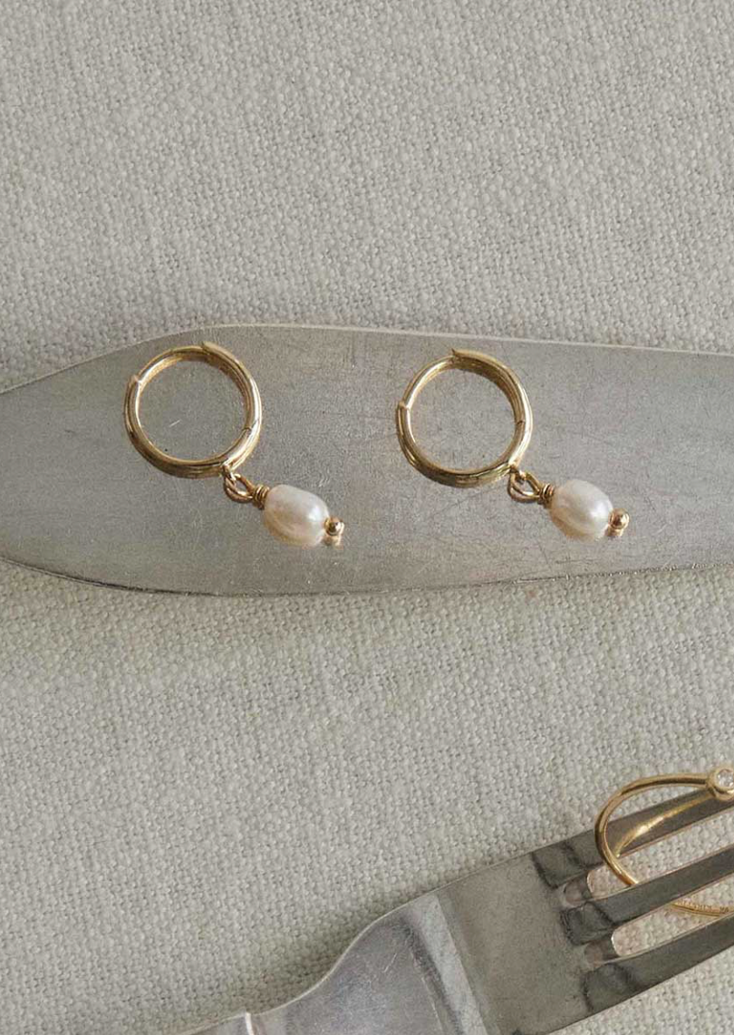 small size gold  Pearl Hoops, highlighting the minimal pearl drop for an elegant, everyday look.