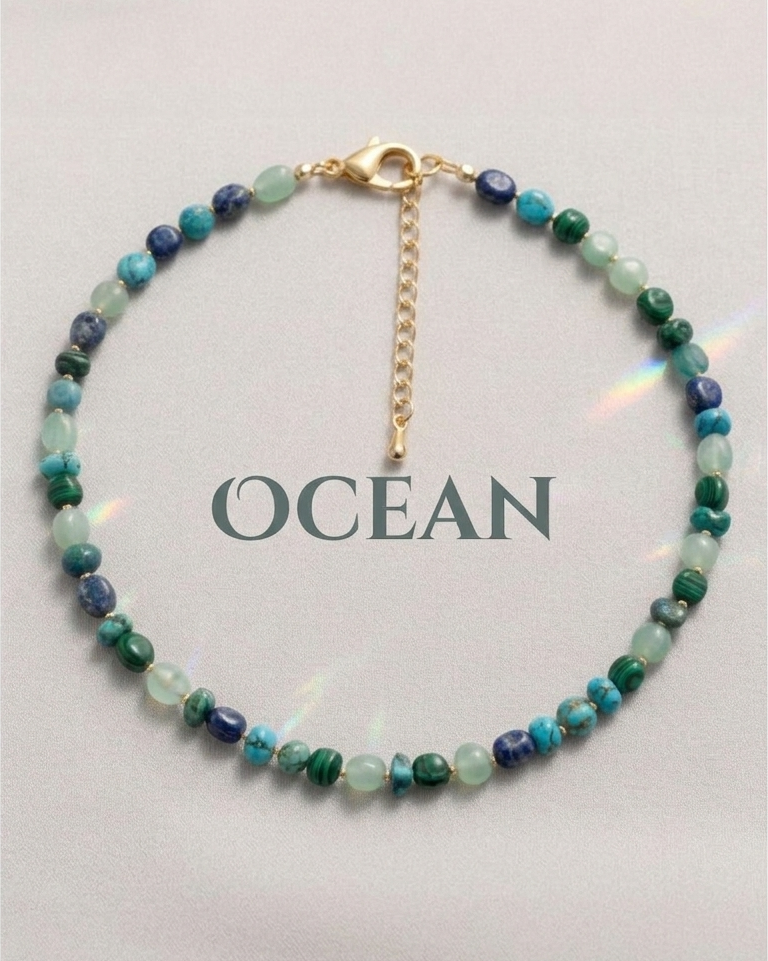 Multicolored beaded bracelet on a white card with 'OCEAN' text