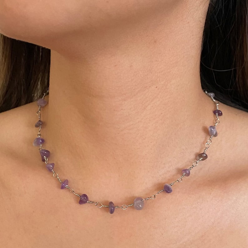Close-up of the Raw Amethyst Necklace on model showing the natural, rough-cut purple stone chips set on a delicate Amethyst Necklace silver Chain.