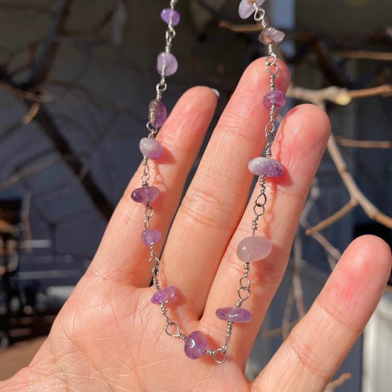 Close-up of the Raw Amethyst Necklace showing the natural, rough-cut purple stone chips set on a delicate Amethyst Necklace silver Chain.