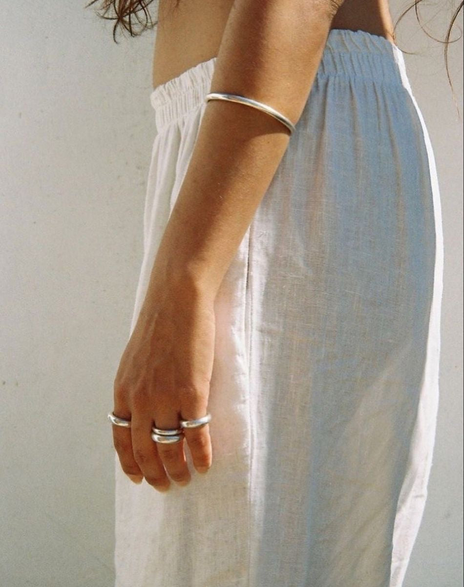 Person wearing a light blue skirt with a plain background