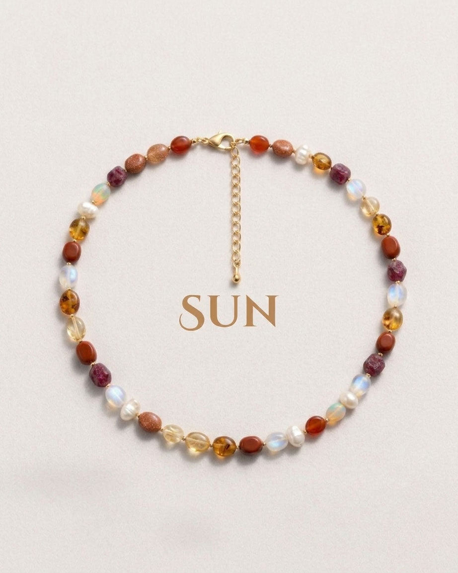 Multicolored beaded necklace with 'SUN' text on a light background