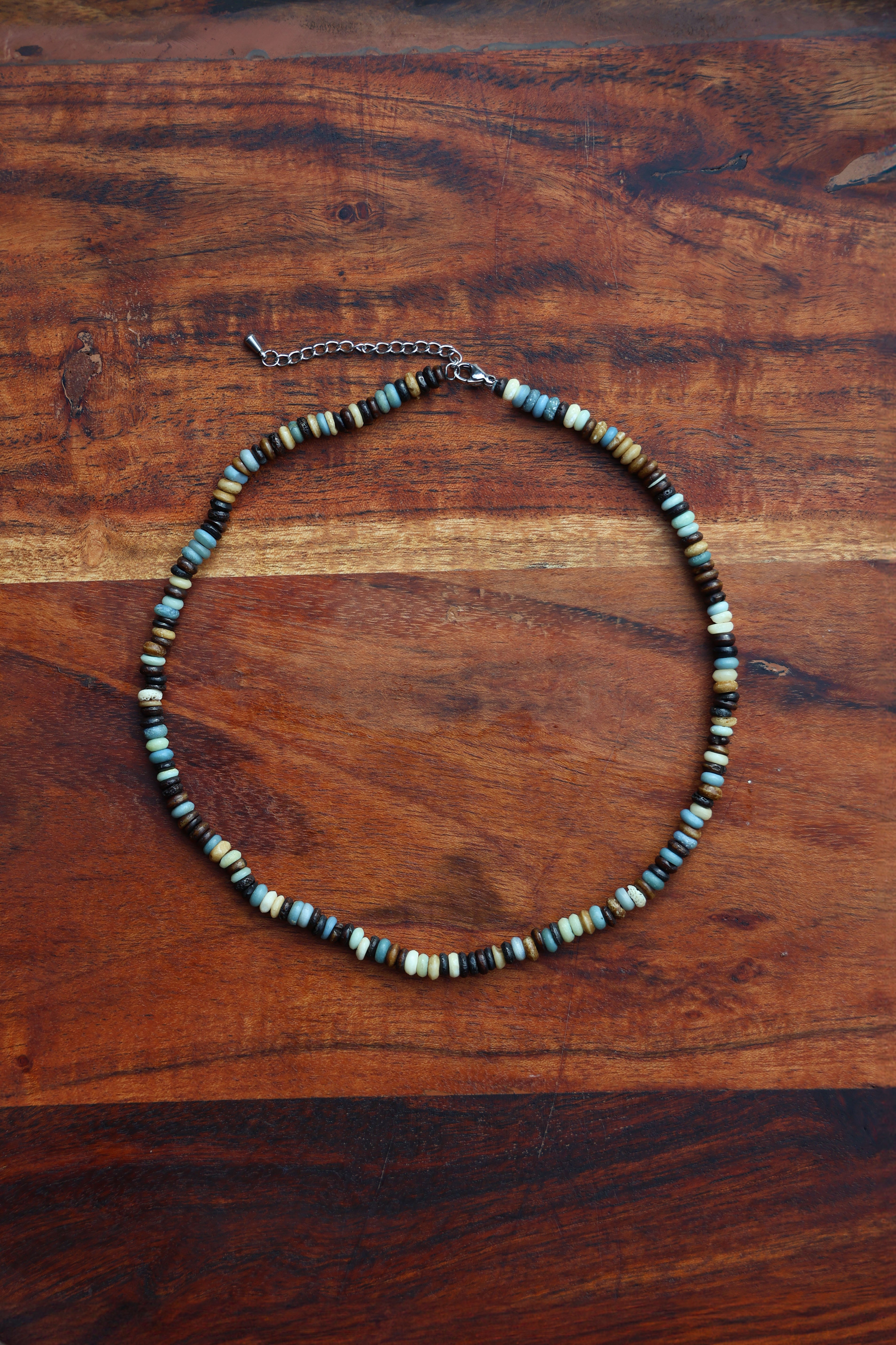 Necklace with beaded chain on a wooden surface