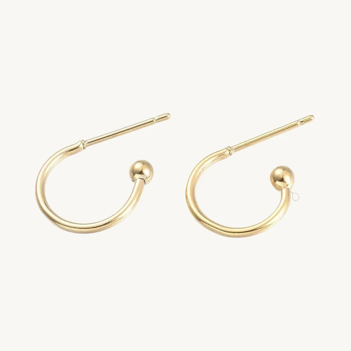 Gold hoop earrings on a white background