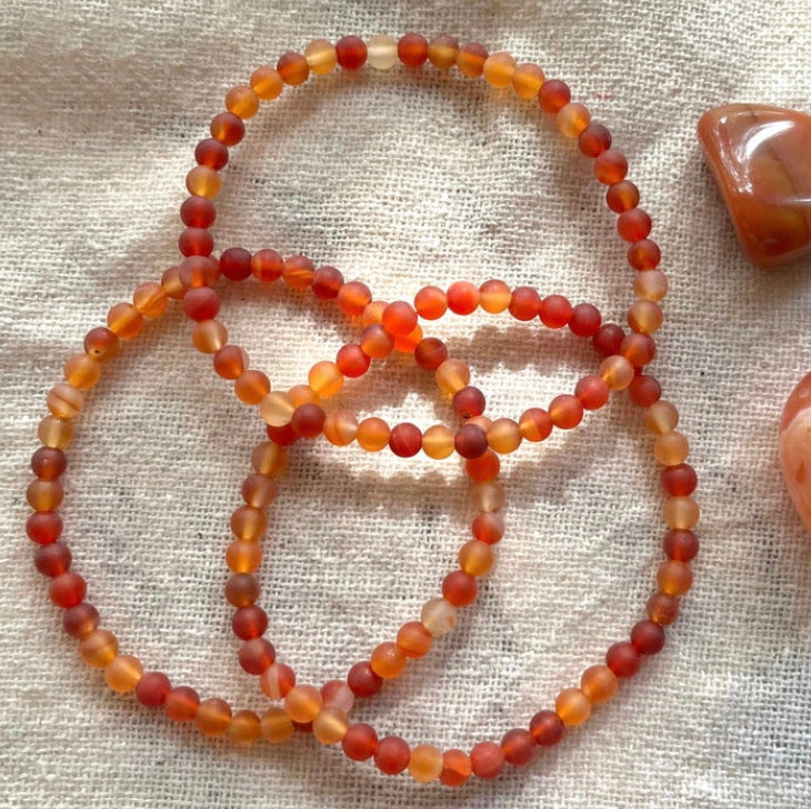 a stack of camelion stacking stretch bracelets made with 4mm beads 