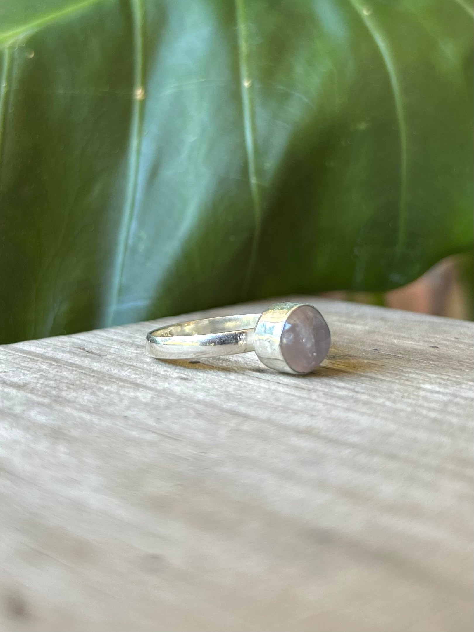 side profile of the Circular amethyst Gemstone Ring showing the dusty Purple Gemstone Sterling Silver Ring centrepiece and the Recycled 925 Sterling Silver Ring band.