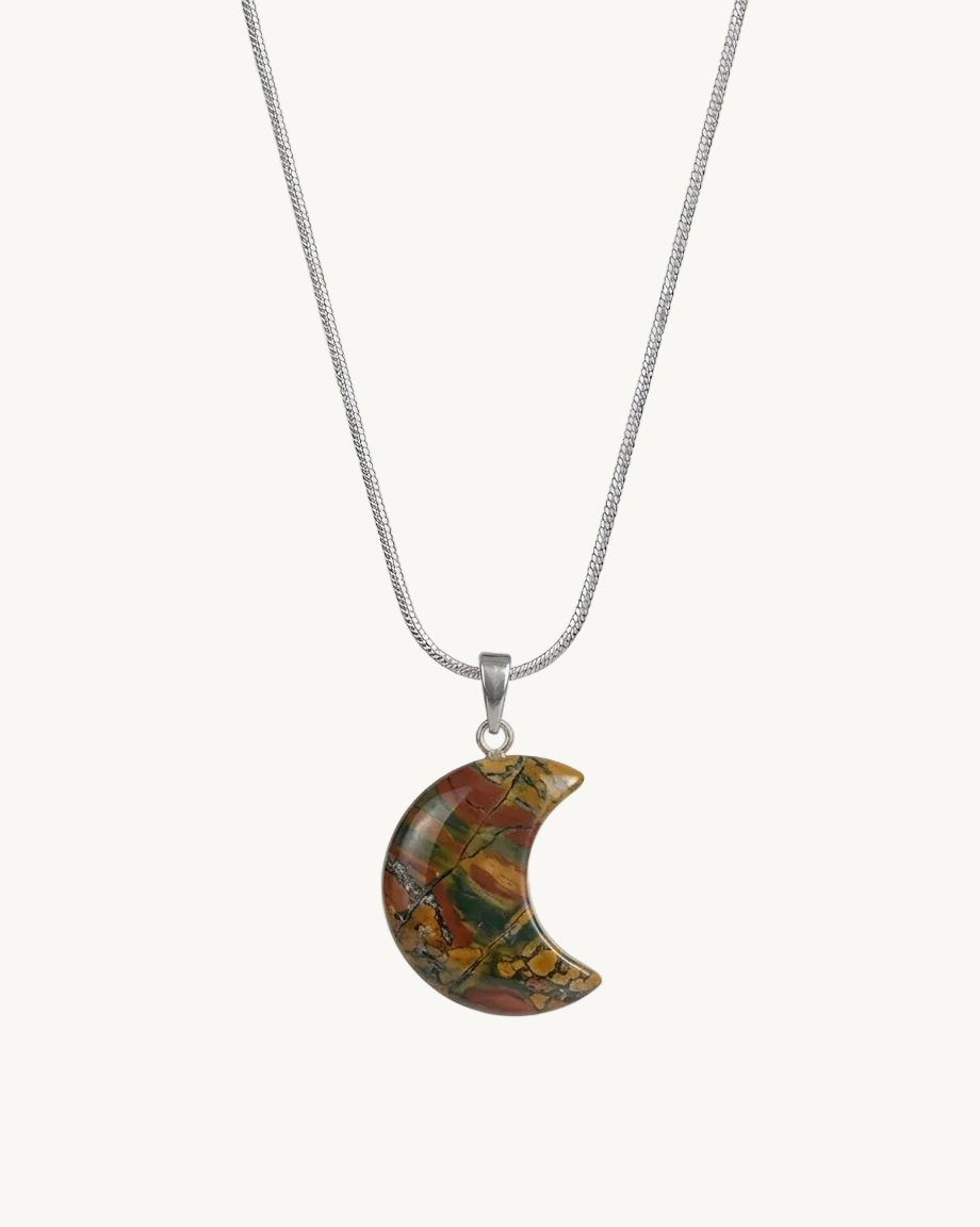 Crescent moon-shaped pendant with multicolored stone on a silver chain against a white background