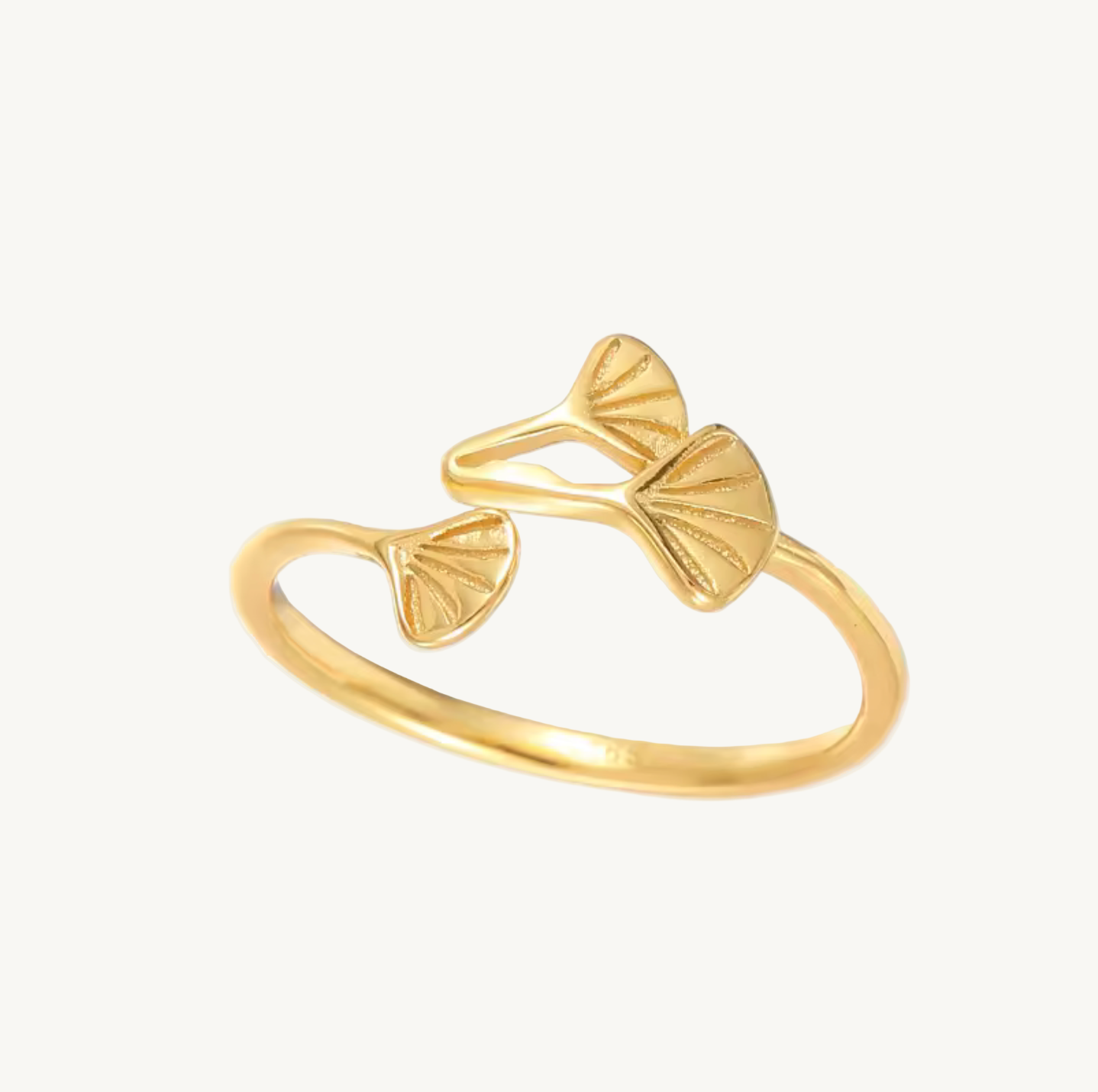 Gold ring with leaf designs on a white background