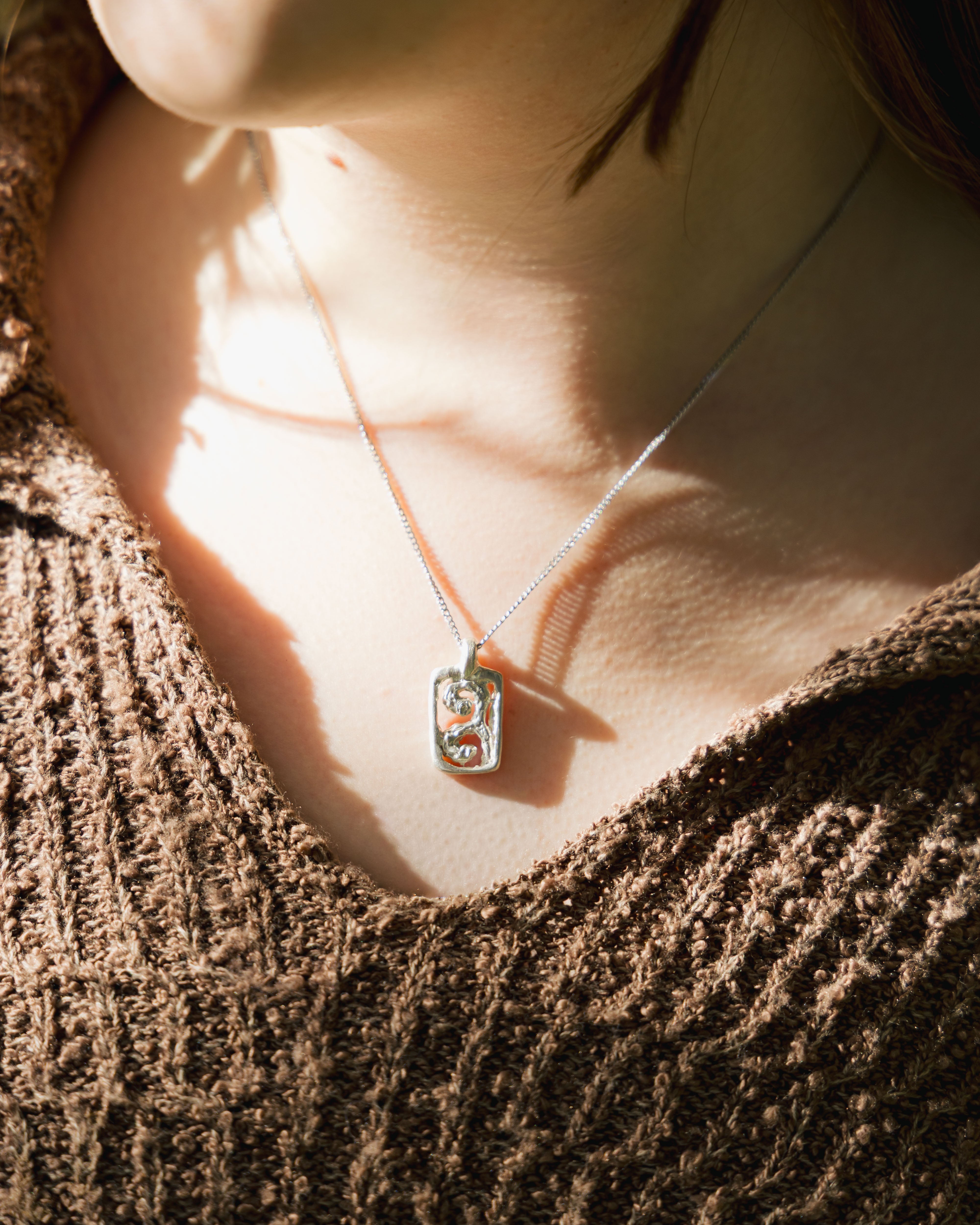 Close-up of a necklace on a textured surface