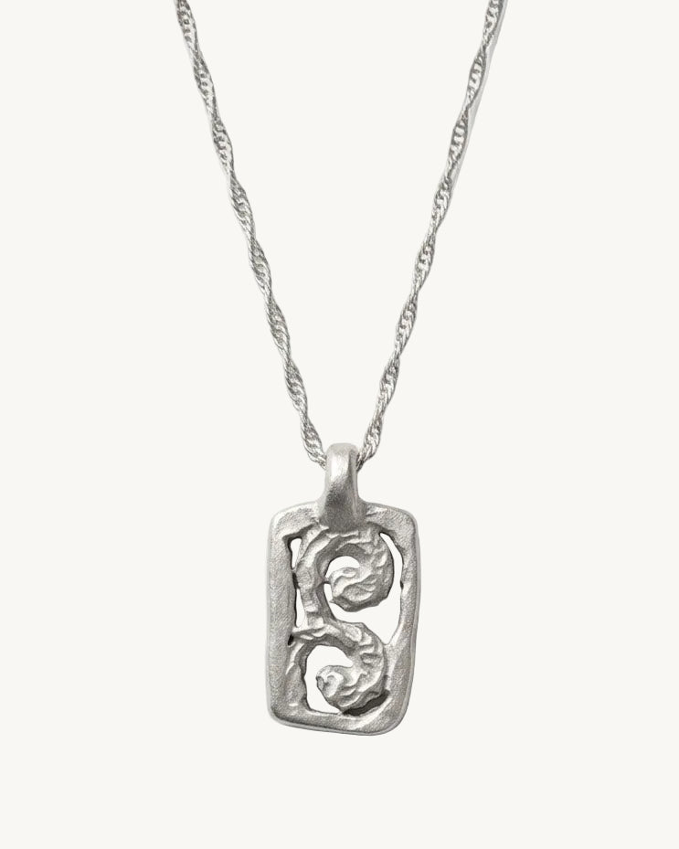 Silver necklace with a pendant on a white background