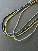 Close-up of the Earth Side ethical crystal necklace featuring long Peridot beads