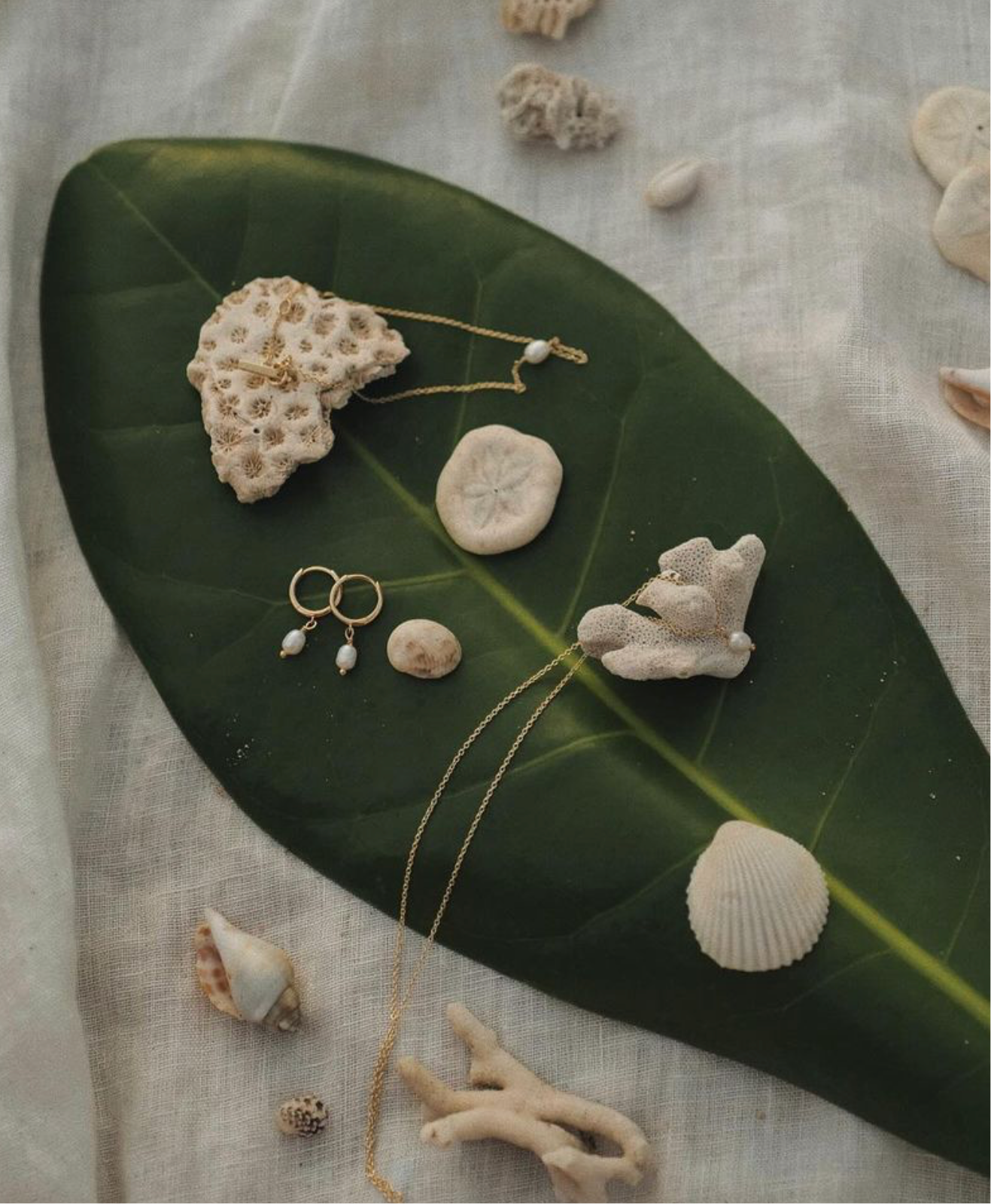 flat lay of gold pearl hoops and matching gold pearl necklaces 