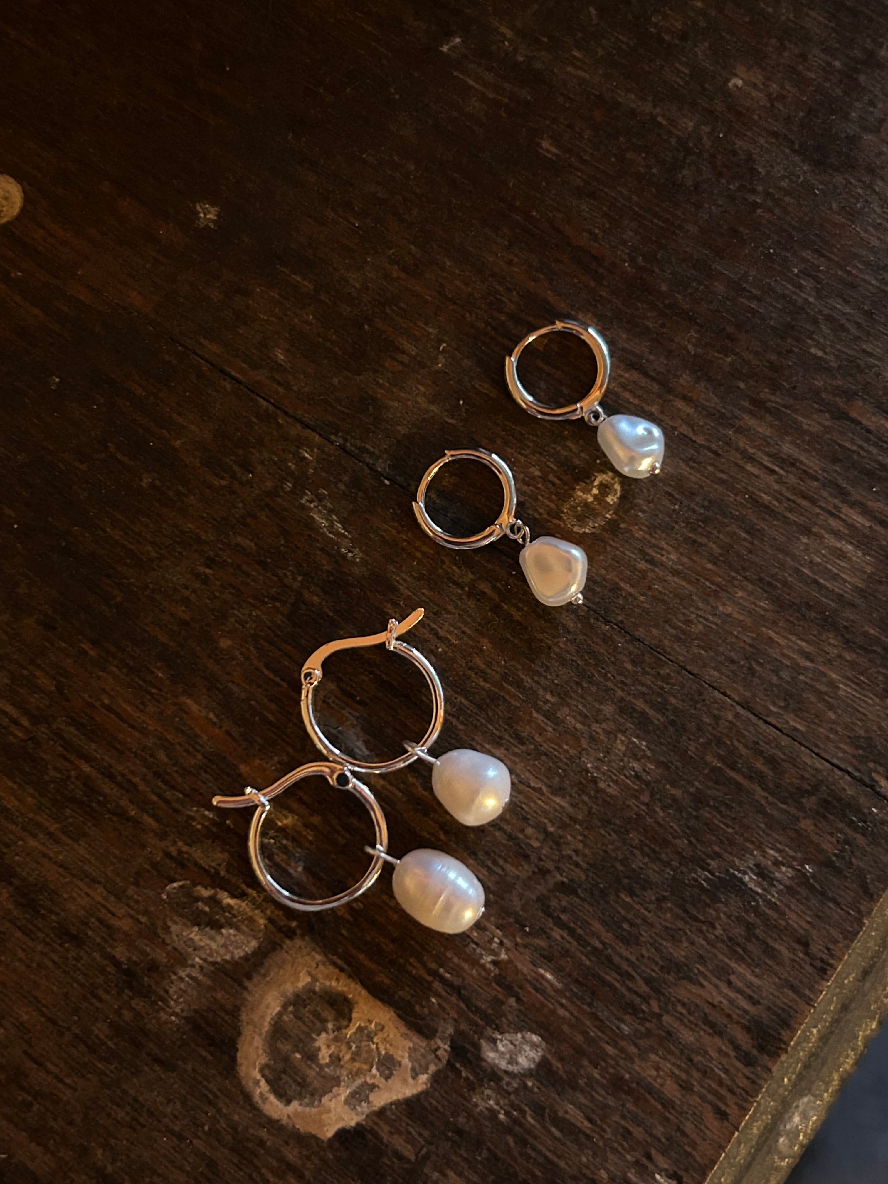 size comparison of small and medium silver hoops 