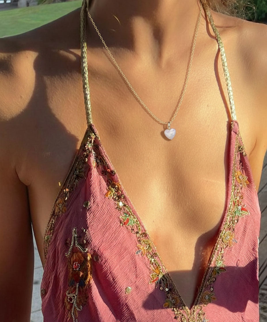 Pink embroidered halter with a pearl heart necklace.