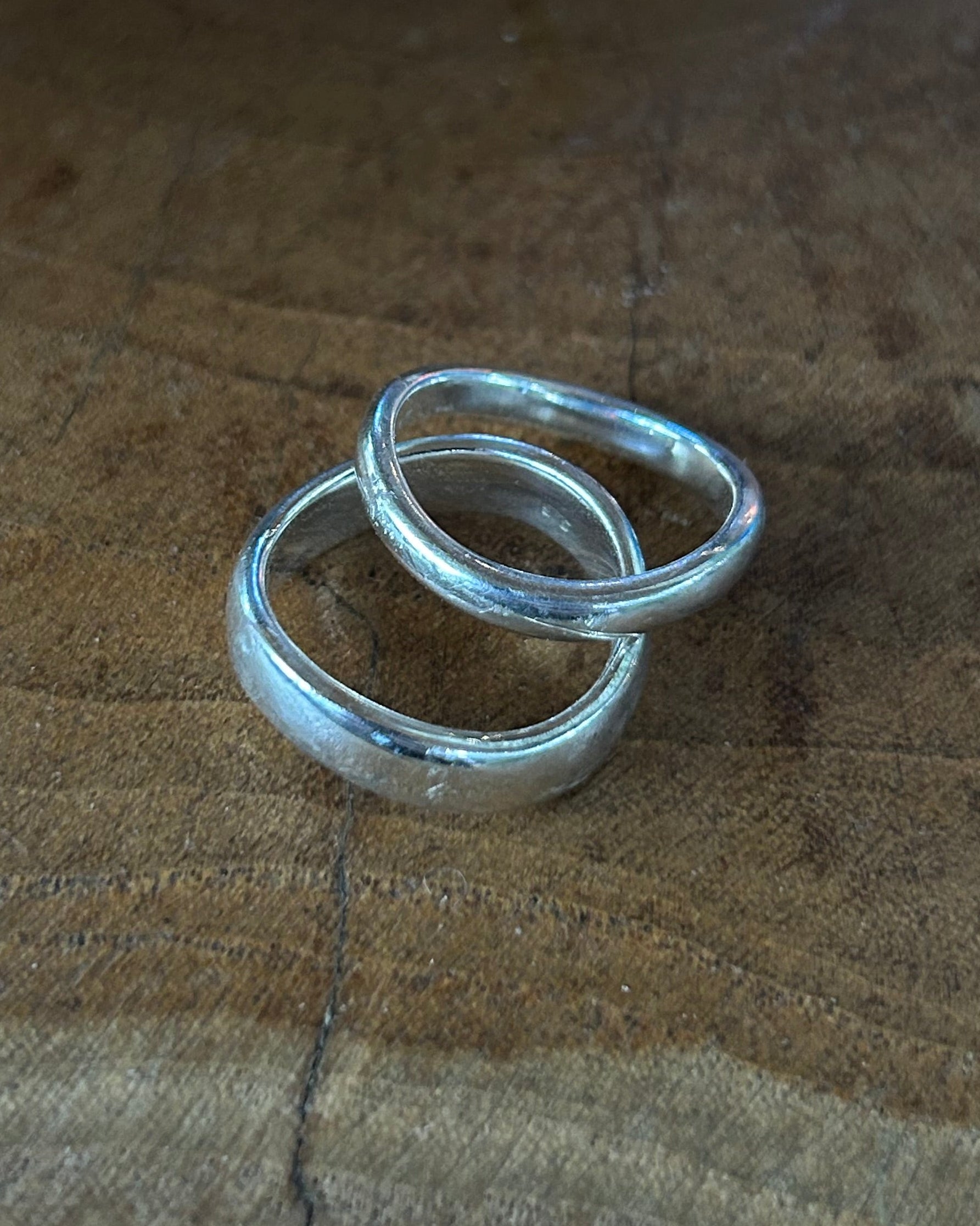 Silver ring on a wooden surface