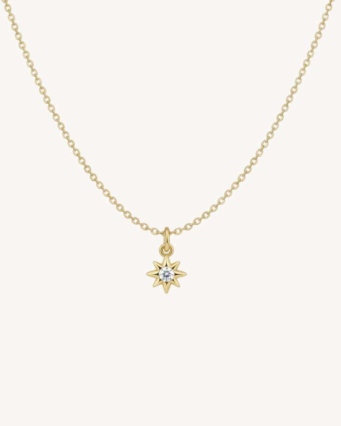 Gold necklace with a star-shaped pendant on a gold chain 